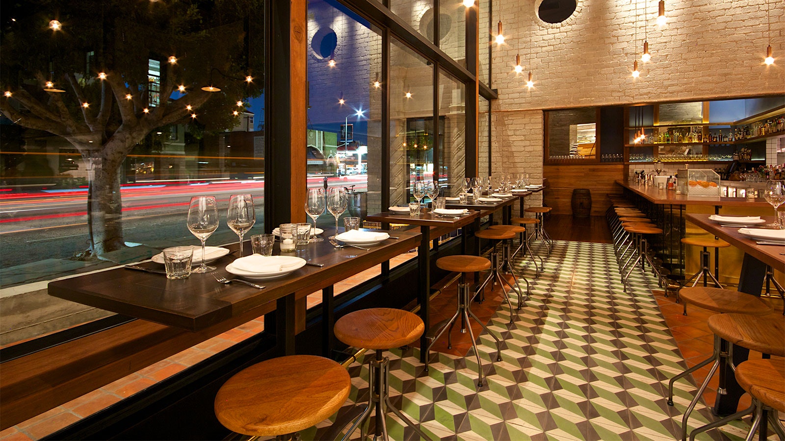 Tables by a large window at République